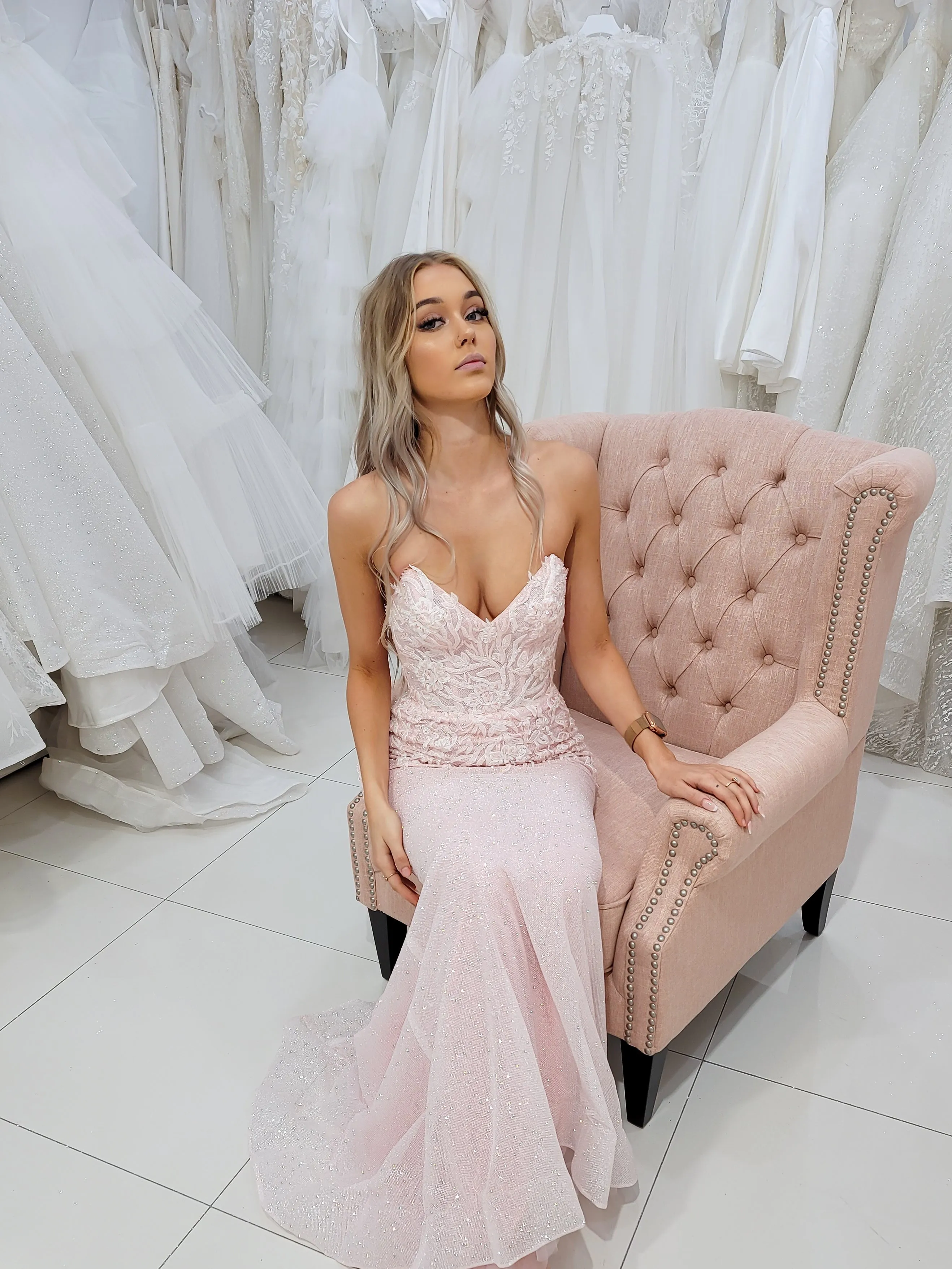 Sparkling pink dress with strapless deep V neckline and corset back fore hire.