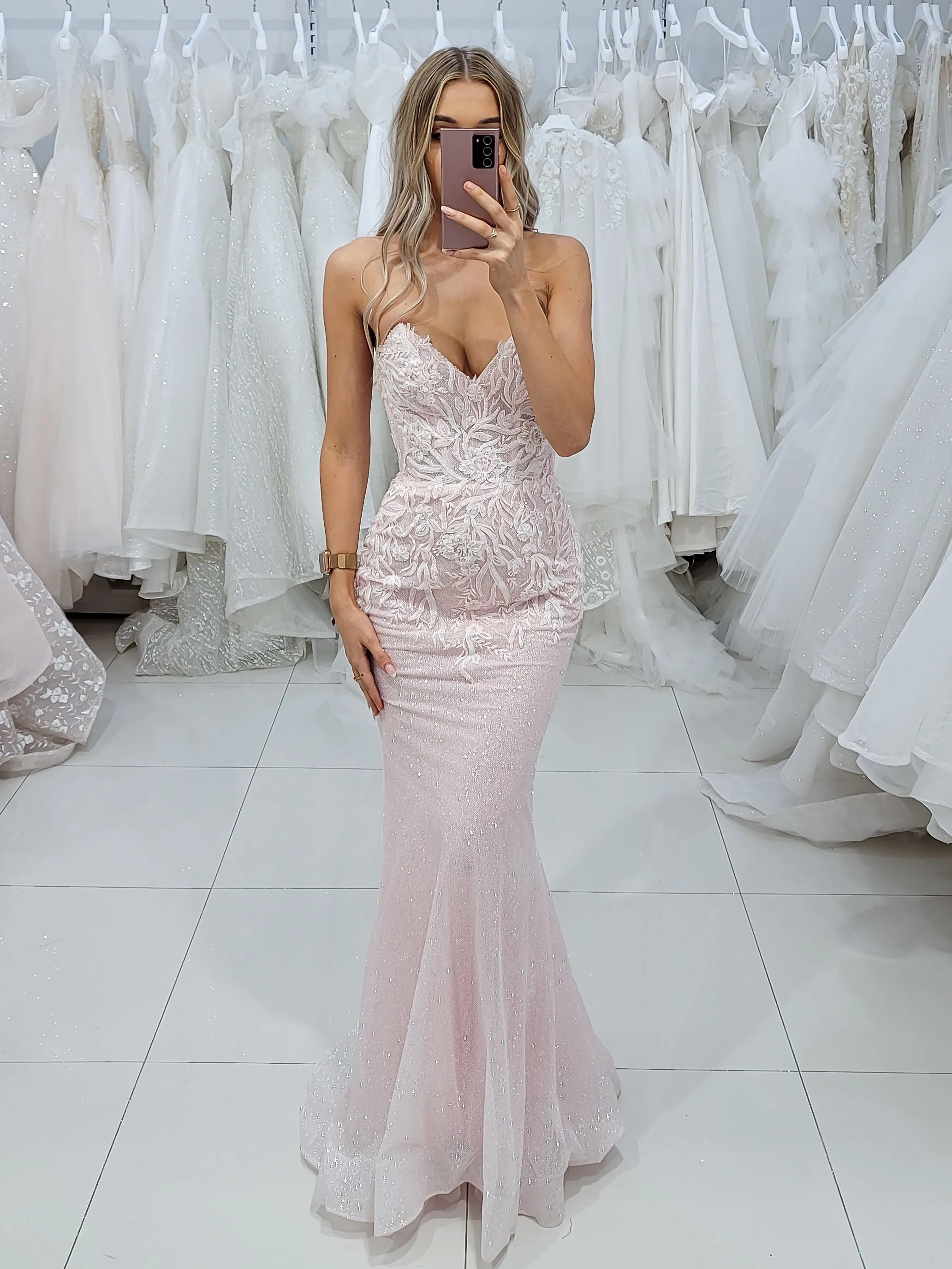 Sparkling pink dress with strapless deep V neckline and corset back fore hire.