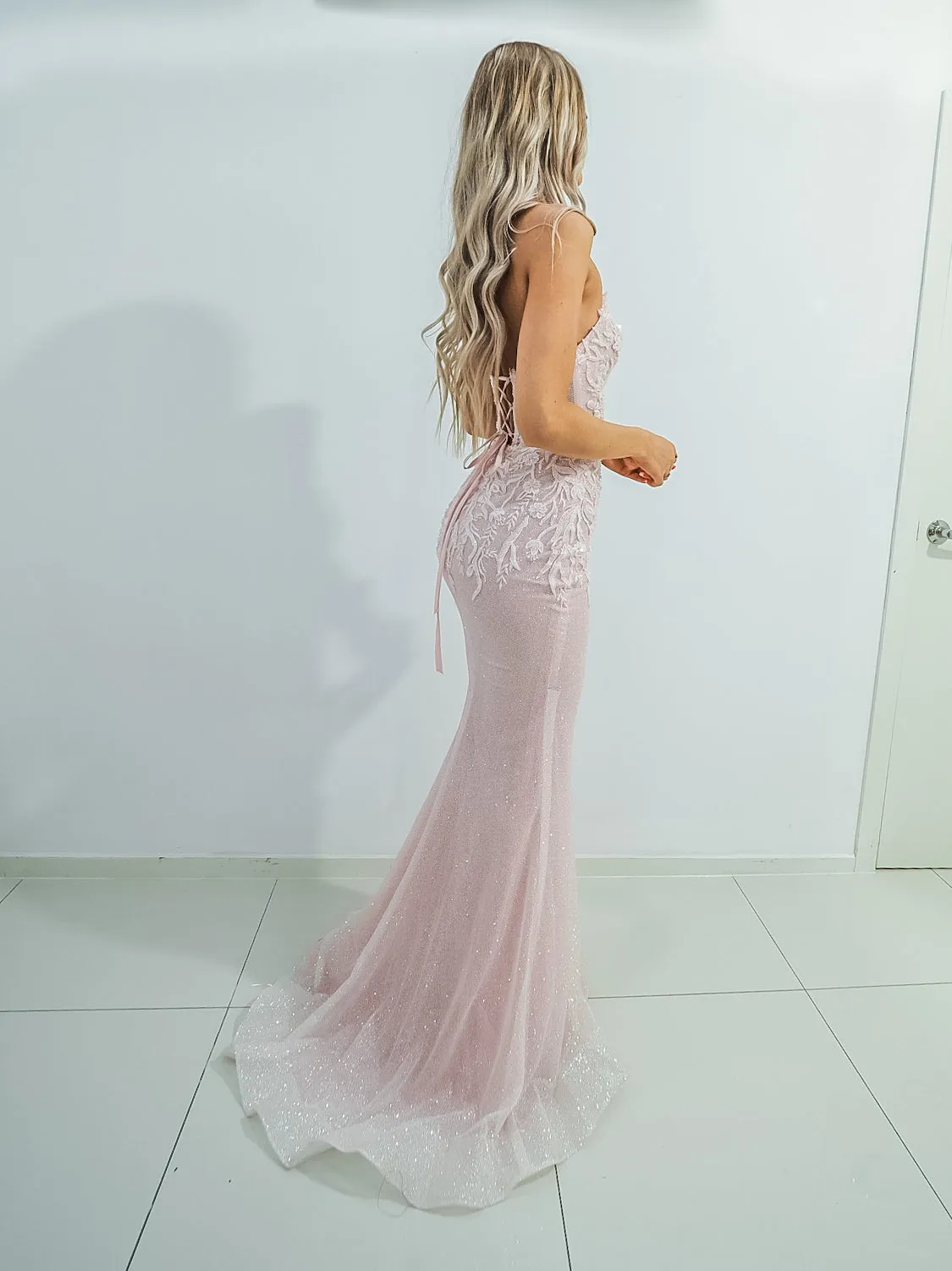 Sparkling pink dress with strapless deep V neckline and corset back fore hire.